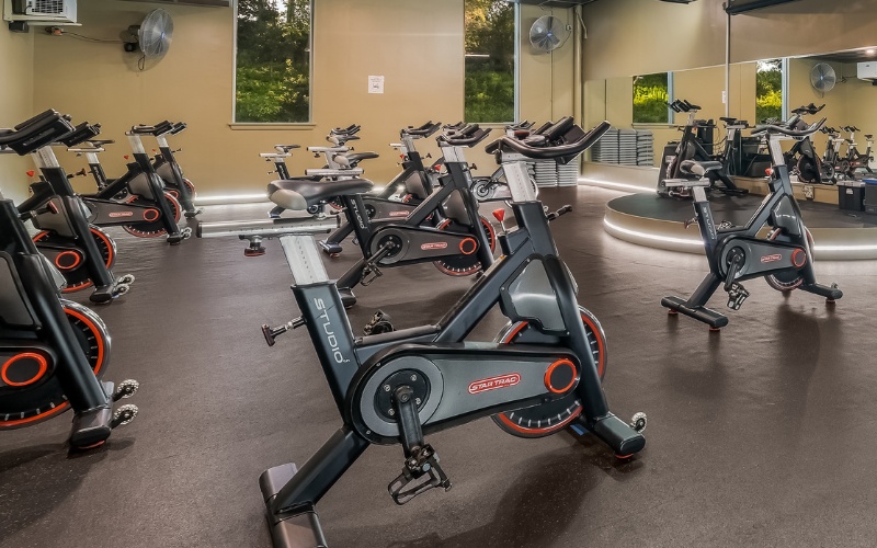 a spacious and clean group fitness spinning studio with cycling machines at a furlong cornerstone gym