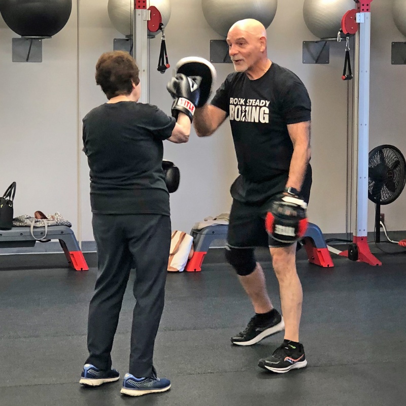 a gym member trains for boxing during a parkinson's fit medical fitness class at a doylestown gym