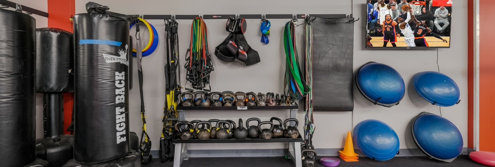 a functional amenities area at a buck's county gym with kettle bells, resistance bands, yoga mats, and more