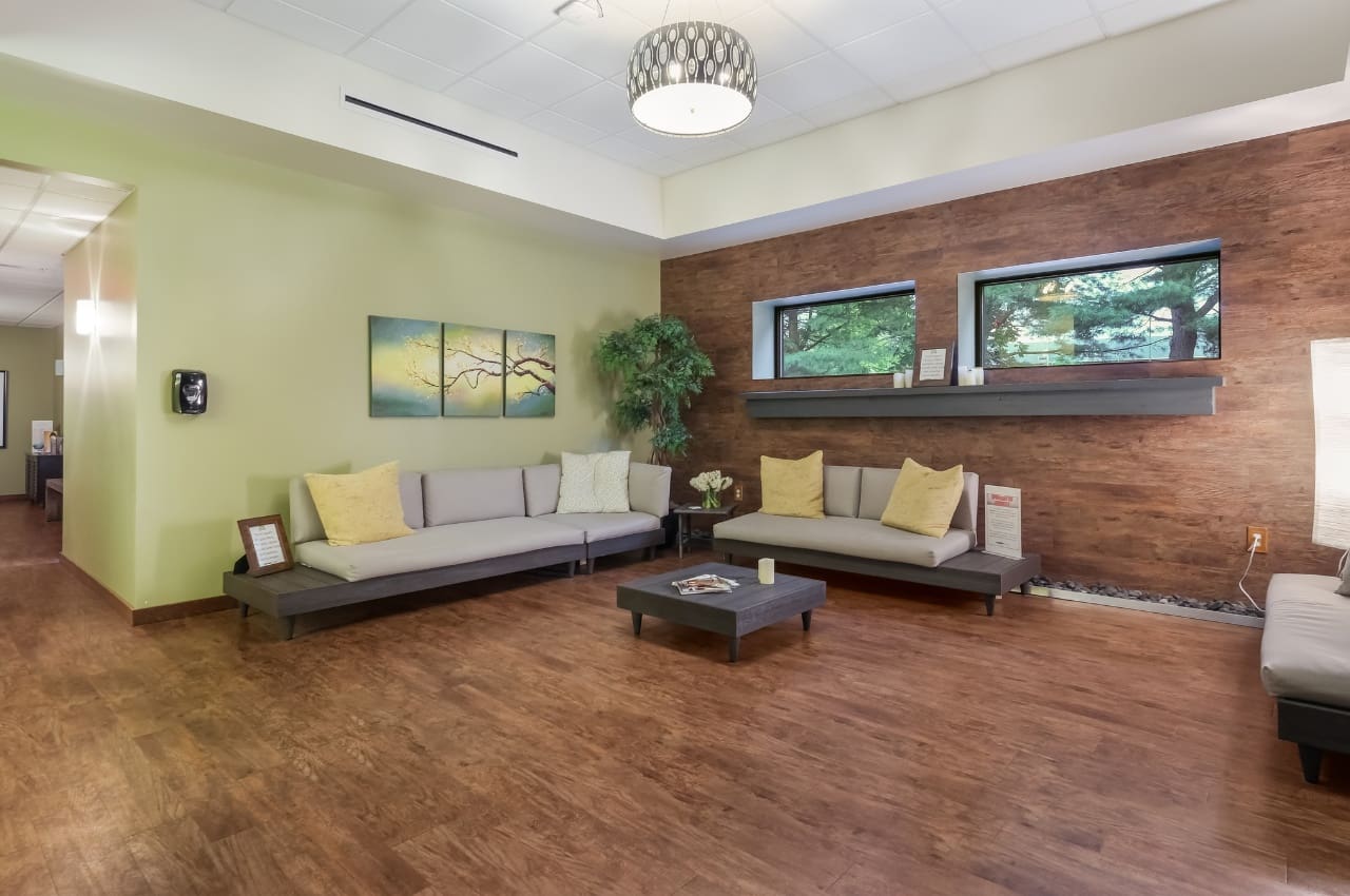 a spacious waiting room with couches and natural lighting at a buck's county spa