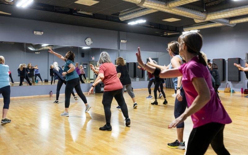 gym members dance during a group fitness class at cornerstone health and fitness at cornerstone health and fitness