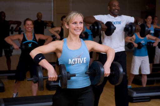 People lifting dumbbells in a Mossa Group Active class.
