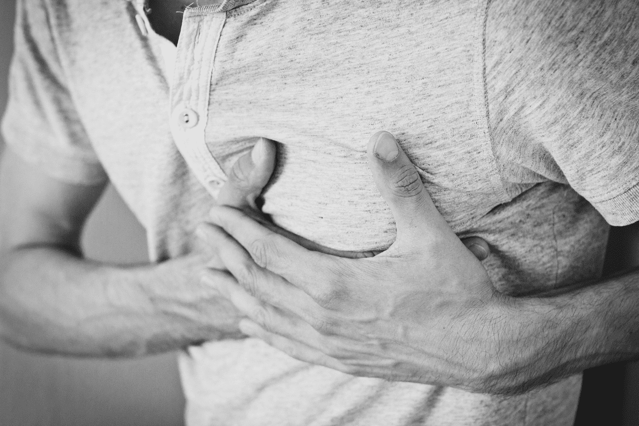 Man holding chest due to preventable heart attack
