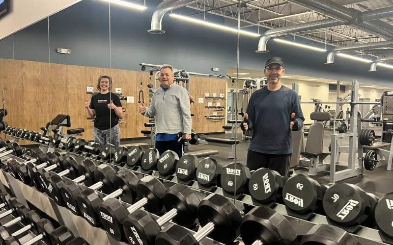 3 members pose after a strength training workout at a modern buck's county gym
