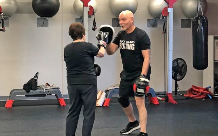 a gym member punches a target during a parkinson's boxing medical fitness program at a health club in buck's county