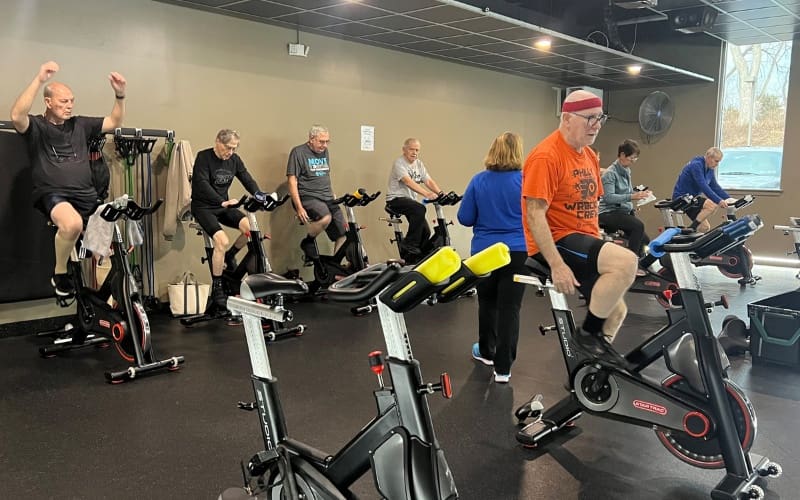 a group of senior gym members at a group fitness cycling class at a bucks county gym