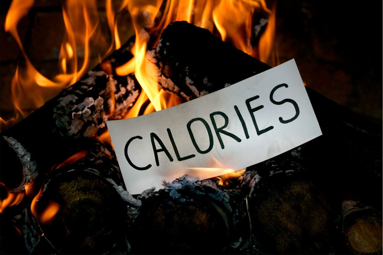 Image of a piece of paper with the word calories written on it burning up.