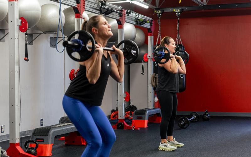 gym members use barbells for functional training at cornerstone gym near me