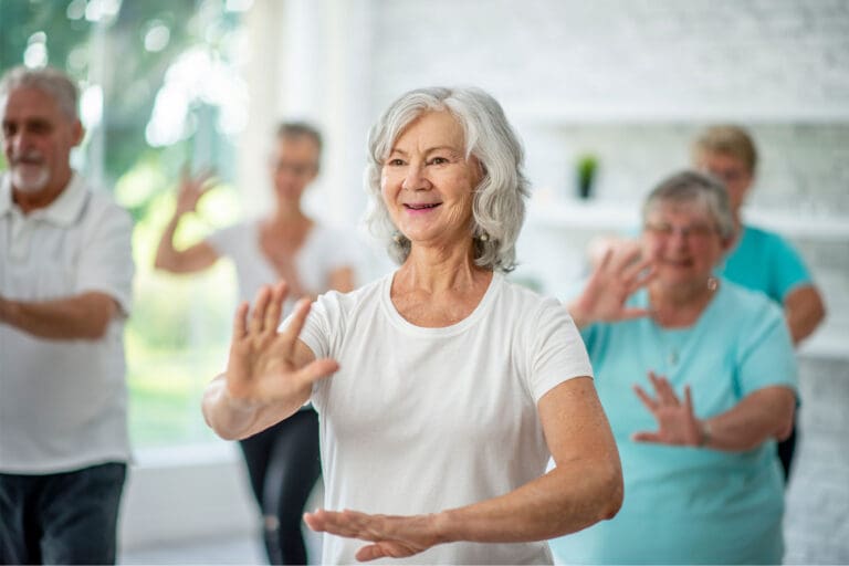 Older people taking Tai Chi class.