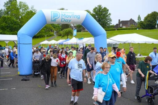 People crossing the finish line of the 2024 Parkinson's Moving Day walk.