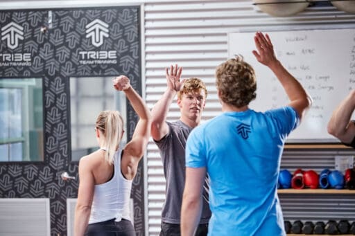 People high fiving after a hard workout.